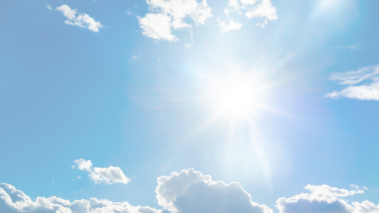 Blue sky with white clouds and sun